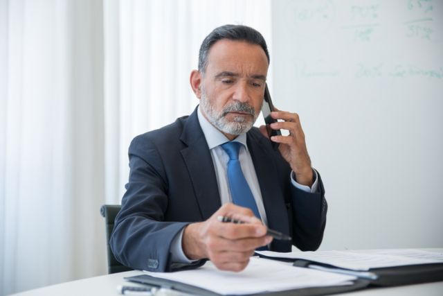 Attorney Jaime Madrigal speaking with a client by phone
